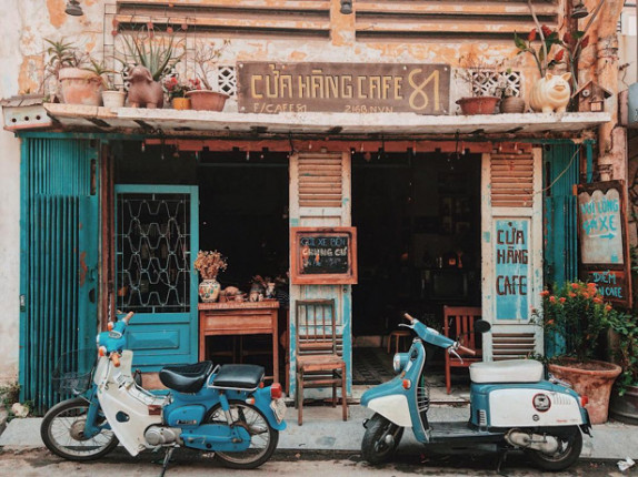 Rustic café storefront with two vintage scooters
